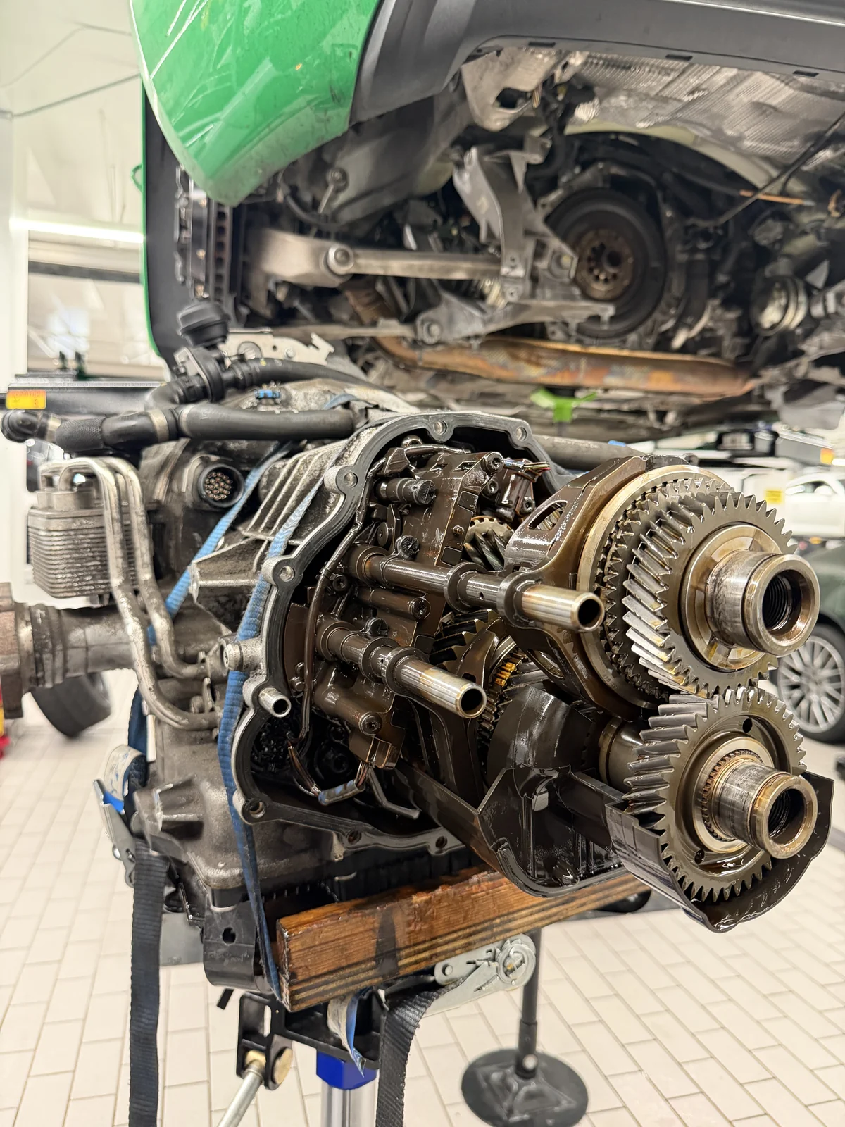 718 Cayman S 7-speed PDK on a transmission jack under the car, with the gear stacks exposed